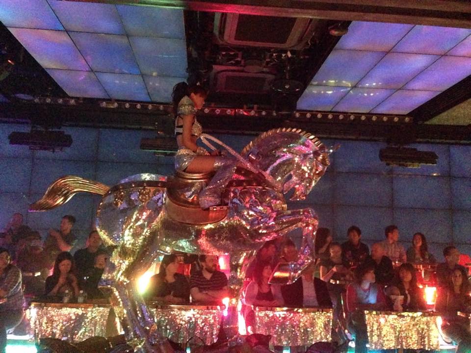 Girl singer riding silver horse at Robot Restaurant