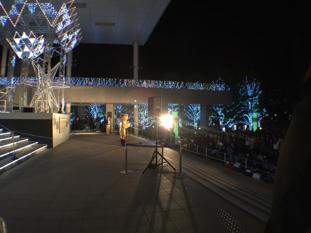 J-Pop band playing under Gundam statue